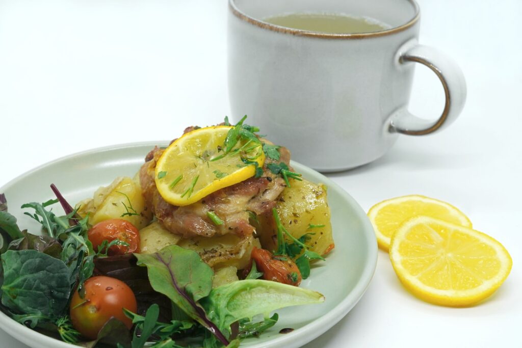 a plate of food next to a cup of tea