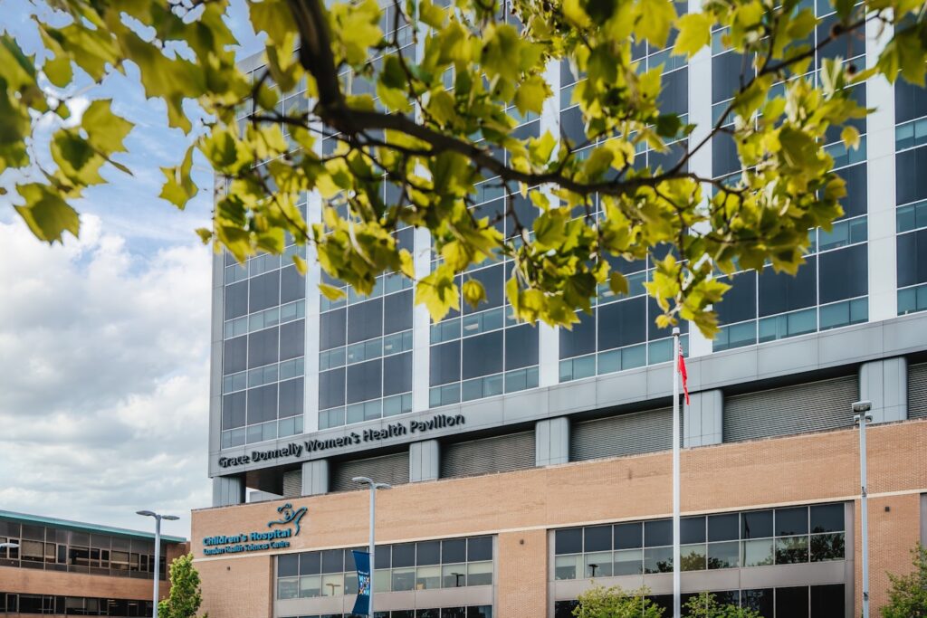 Modern hospital building with trees in foreground